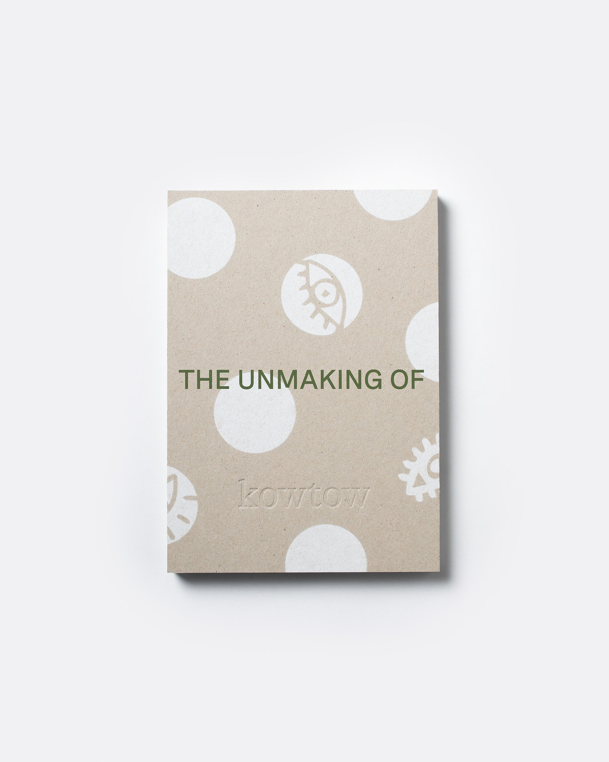 A square kraft paper notebook or book cover with white polka dots and minimalist illustrations, featuring the text 'THE UNMAKING OF' and the brand name 'kowtow' in green, shown on a light gray background.