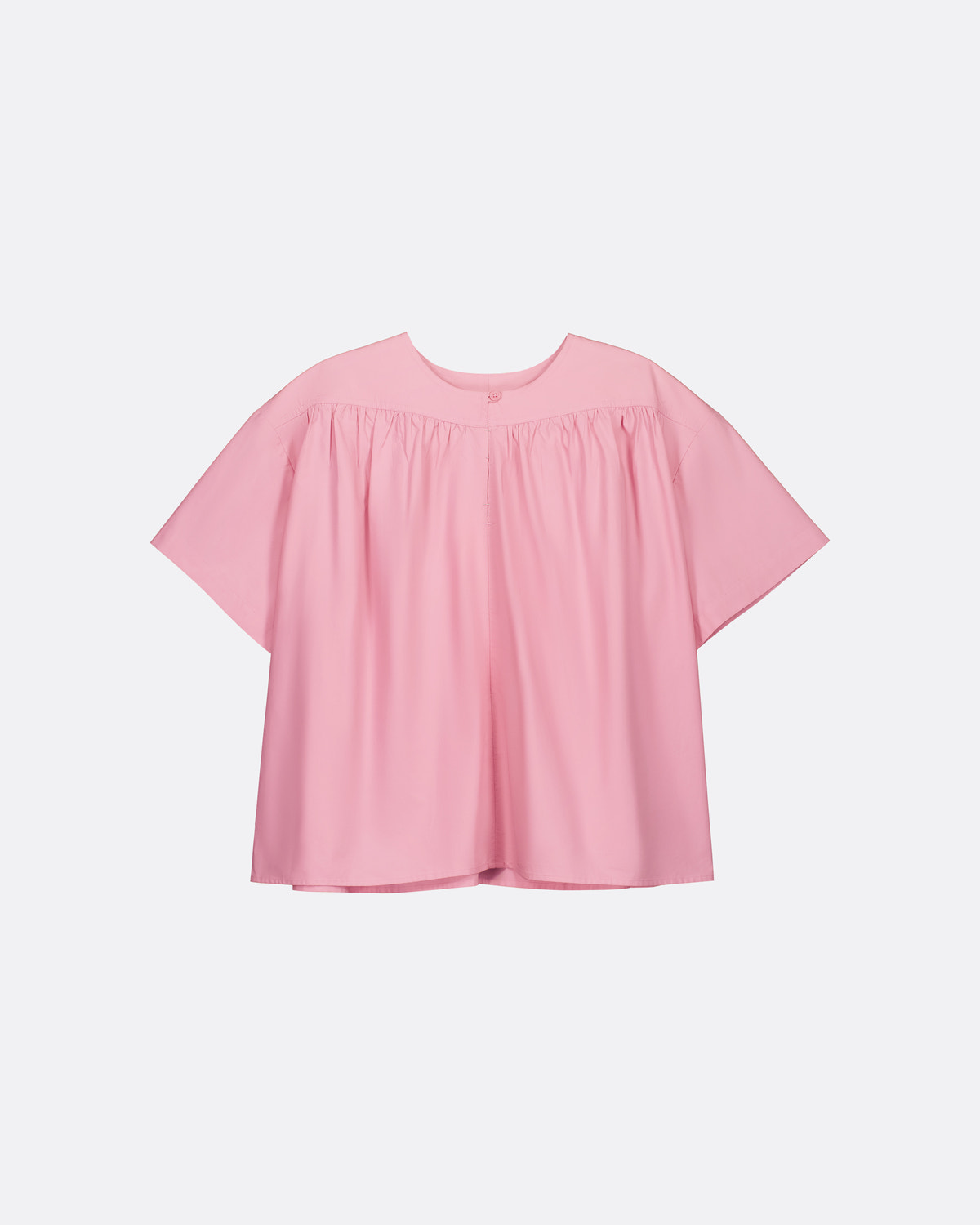 A light pink short-sleeve blouse with a gathered, smocked bodice and a relaxed, oversized silhouette, shown against a plain light gray background.