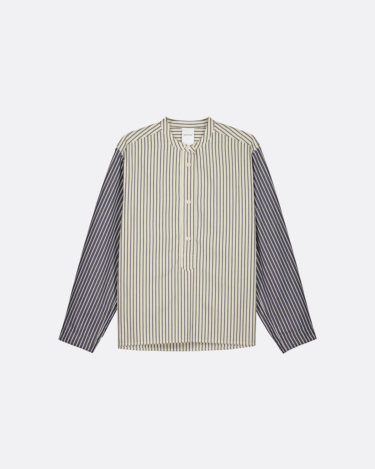 A long-sleeve button-up shirt with a beige and white vertically striped body and solid dark gray sleeves, displayed flat against a light gray background.