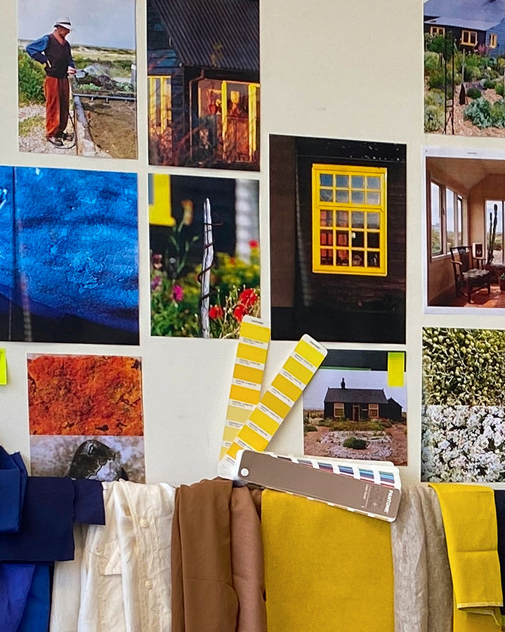 A styled interior design board or mood board featuring multiple printed photographs, fabric swatches in blue, cream, brown, and yellow, and two yellow-and-white striped swatch cards pinned against a light wall.