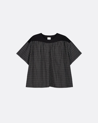 A short-sleeve top with a solid black yoke and a black-and-white micro-check patterned body, displayed flat against a light gray background.