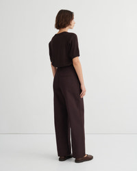 A model shown from the back wearing a dark brown short-sleeve top and matching dark brown wide-leg trousers.