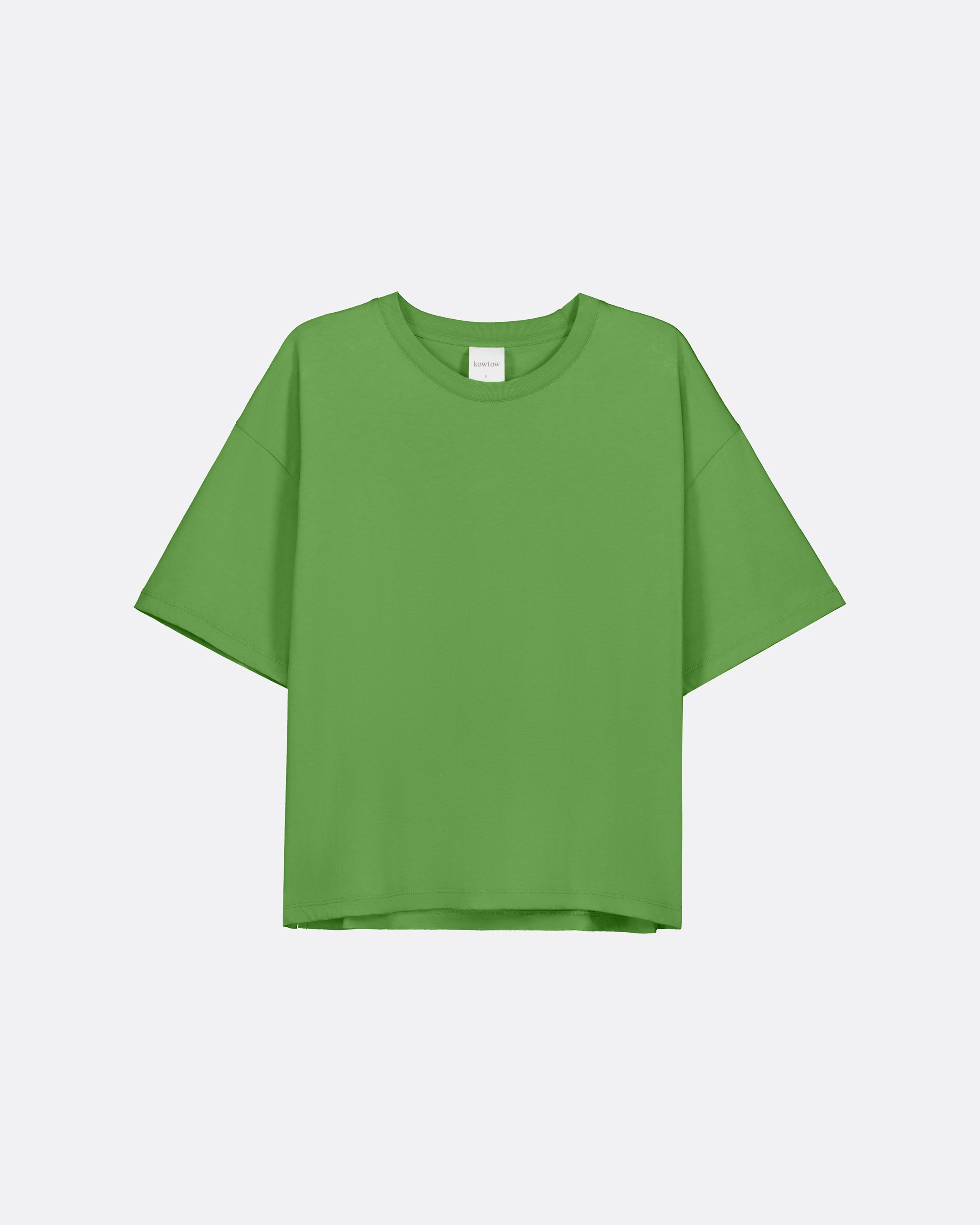 A bright green relaxed boxy t-shirt against a light grey background.
