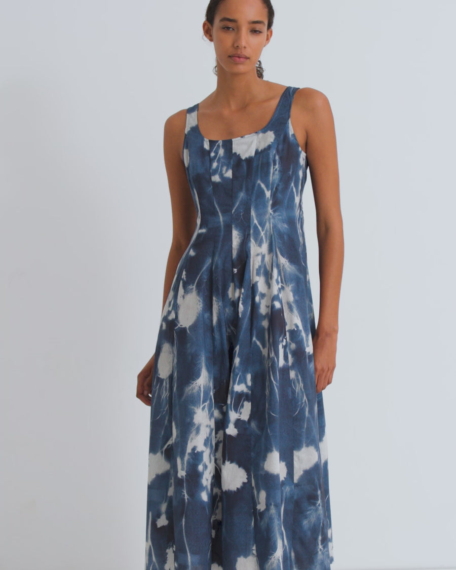 A women wearing a printed blue floral cyanotype dress.