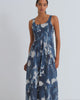 A women wearing a printed blue floral cyanotype dress.