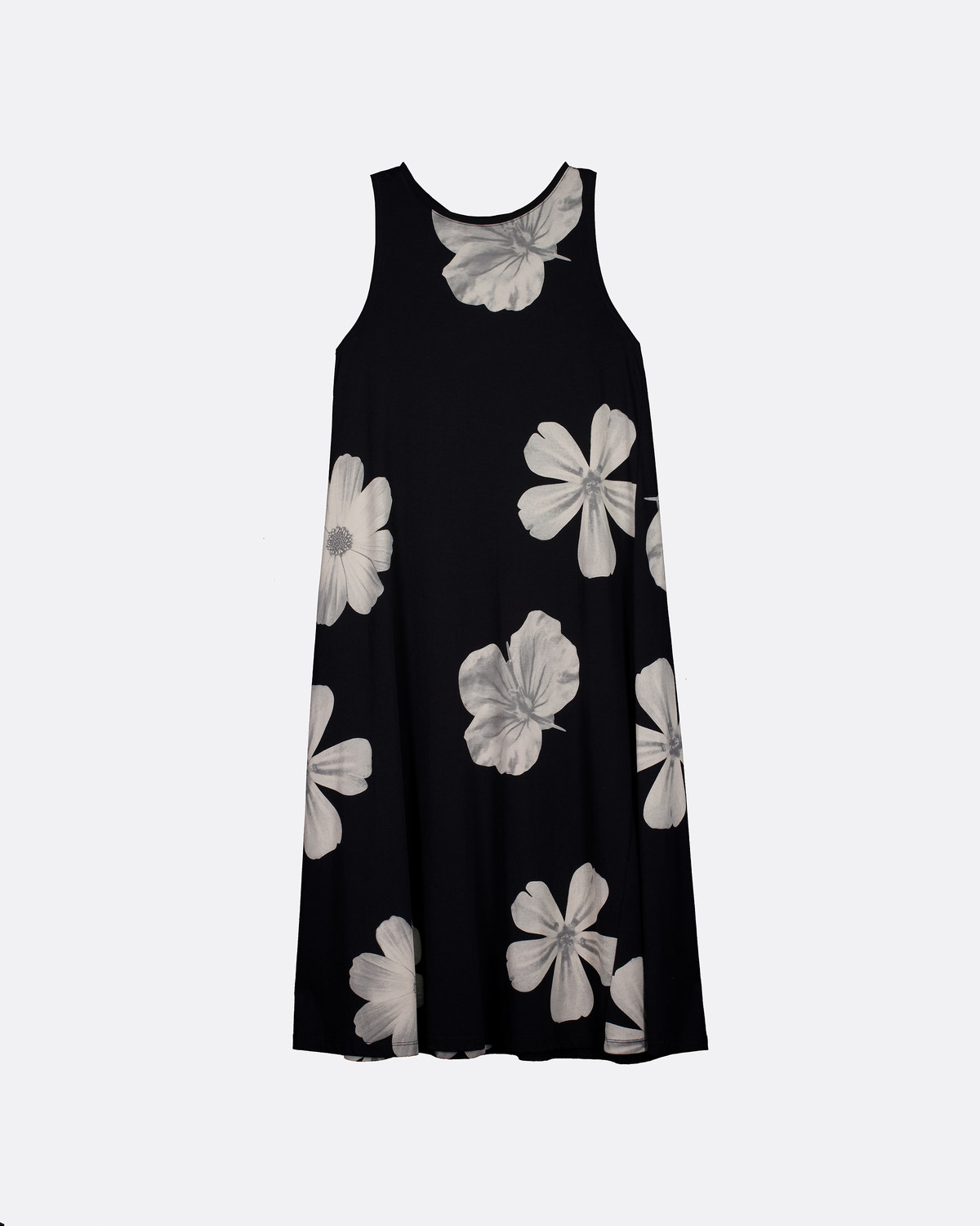 A sleeveless black dress with a large white floral print, displayed against a light gray background.